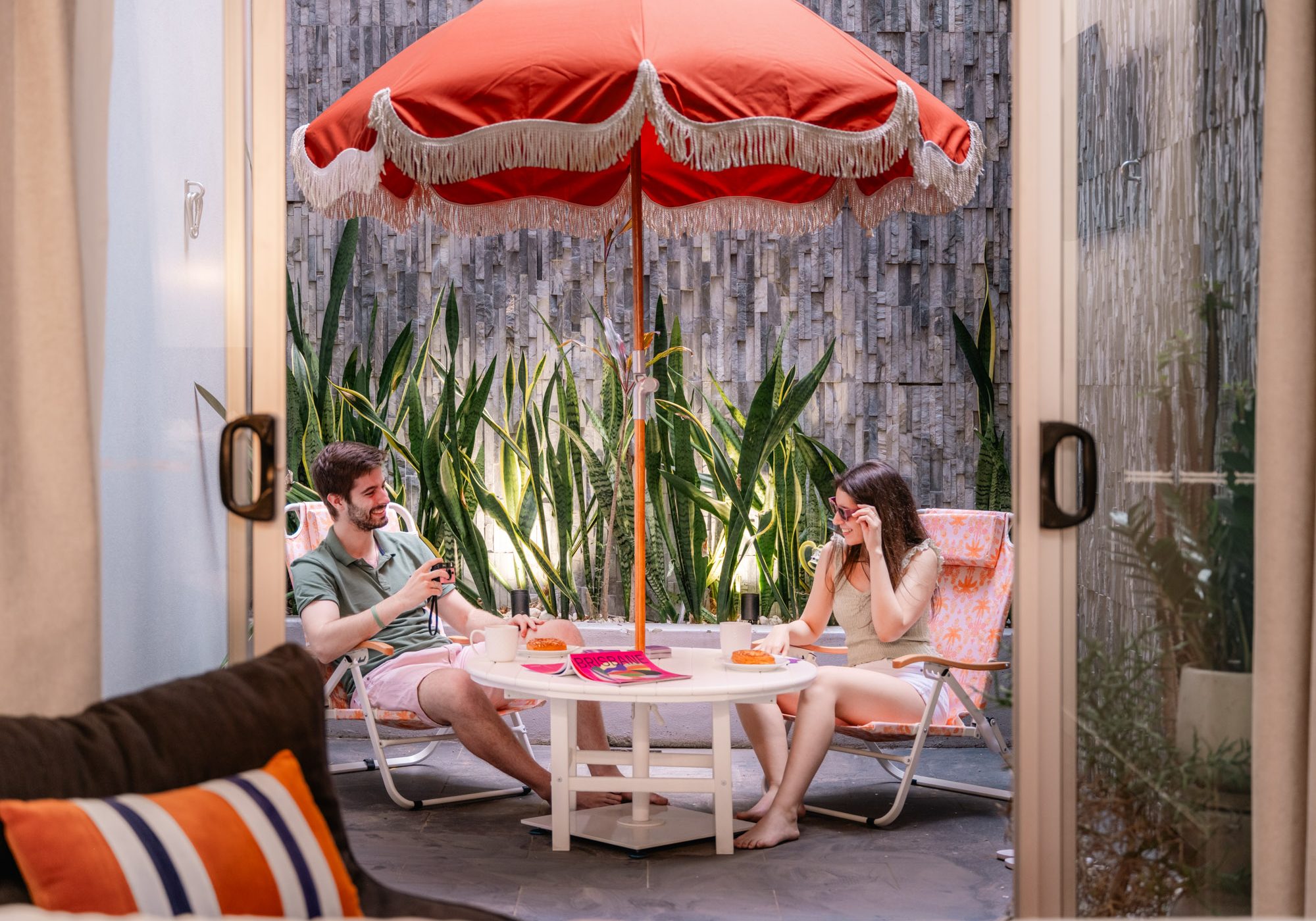 View to courtyard with couple at table in LyLo Brisbane