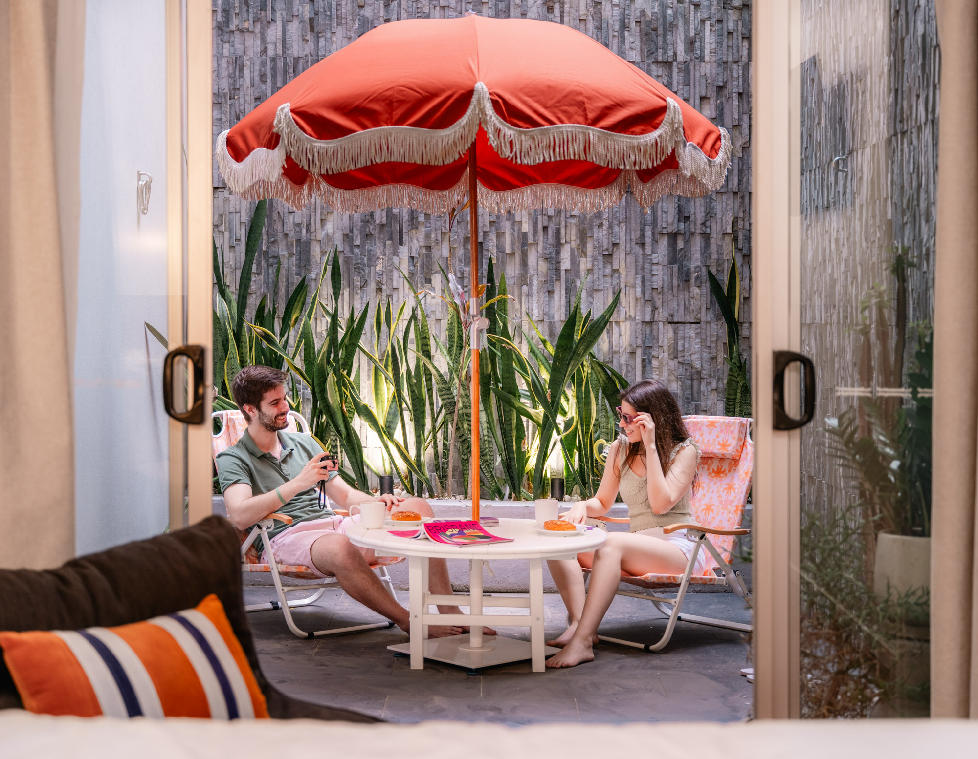 View to courtyard with couple at table in LyLo Brisbane